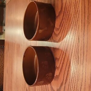 Two dark brown ceramic stoneware dog bowls.  5" in diameter 2 1/4' high